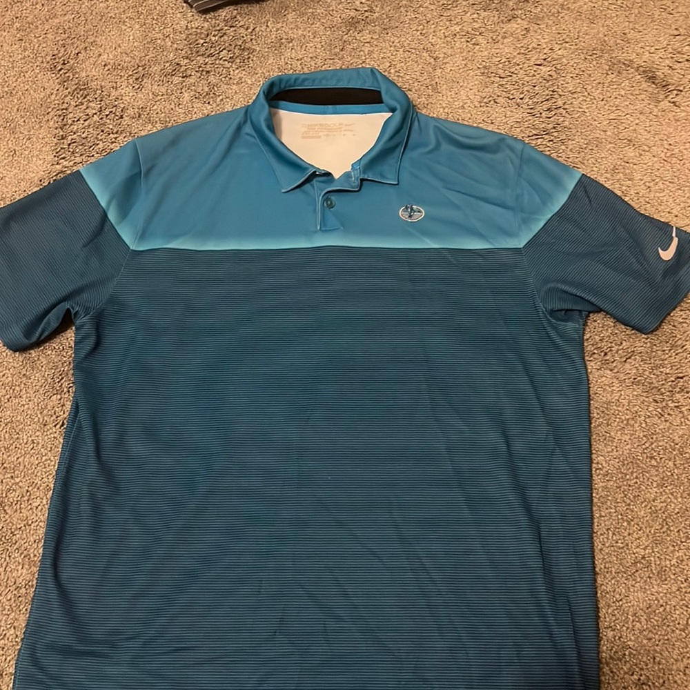 Blue Nike dri-fit golf polo with Reynolds Plantation logo on chest
